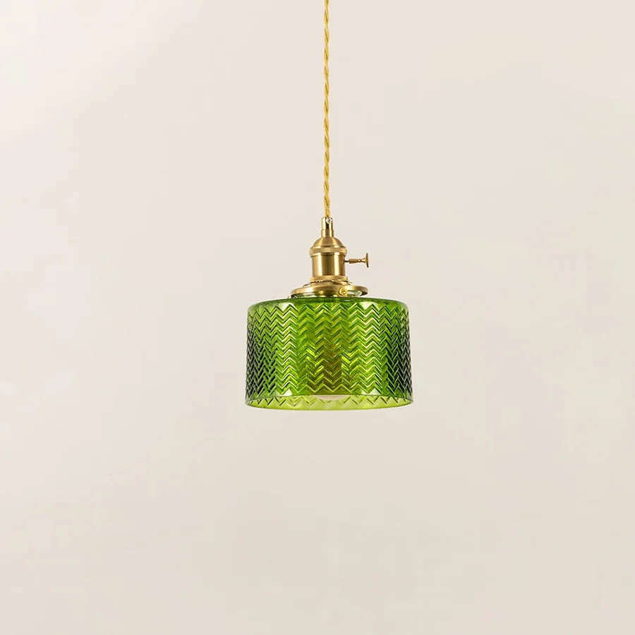 Green textured glass and brass metal pendant light designed for contemporary dining room interiors.