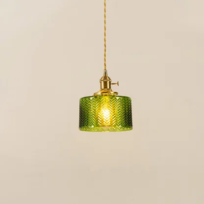 Green textured glass and brass metal pendant light with warm glow for stylish home decor spaces.