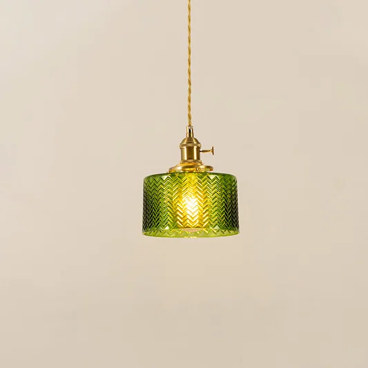 Green textured glass and brass metal pendant light with warm glow for stylish home decor spaces.