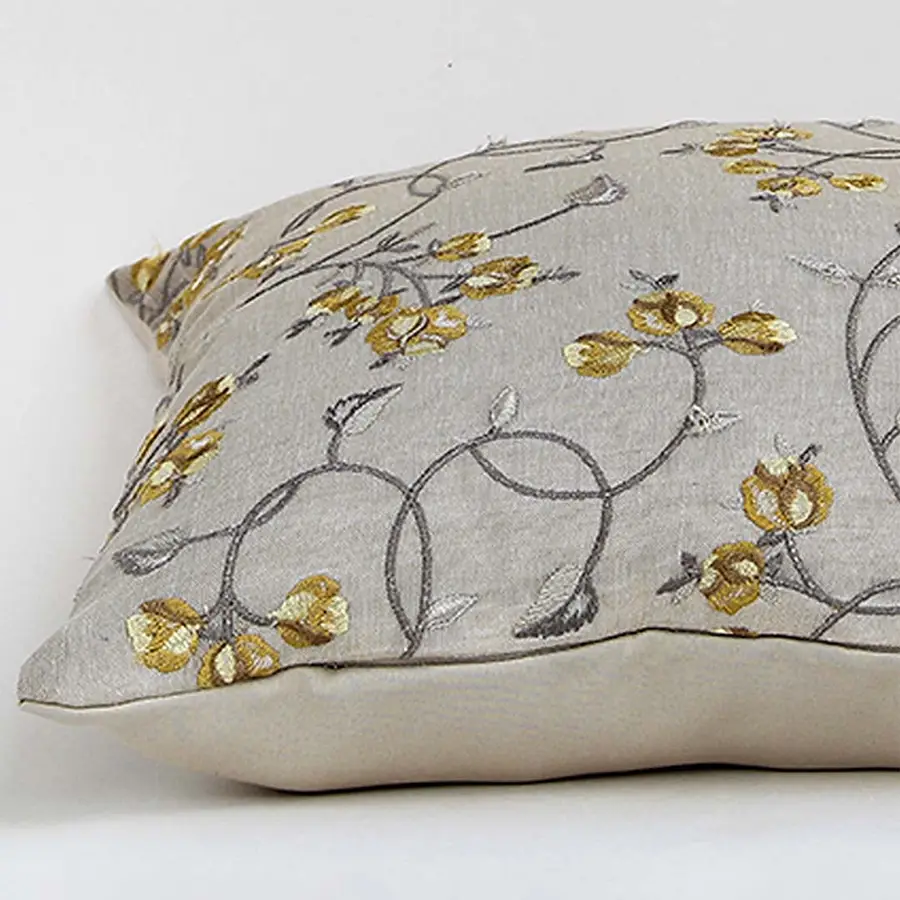 Light beige cotton cushion cover with grey and yellow floral embroidery ideal for modern home décor while providing a soft comfortable and skin friendly fabric experience.