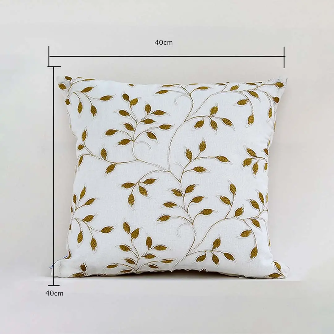 White cushion cover with golden leaf design displayed with guides showing its exact 40 cm x 40 cm size perfect for elegant home décor styling and modern interior accents.