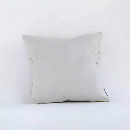 Backside of the cushion cover in beige cotton displayed in a simple view offering a smooth minimal décor style with a breathable gentle and skin friendly fabric texture.