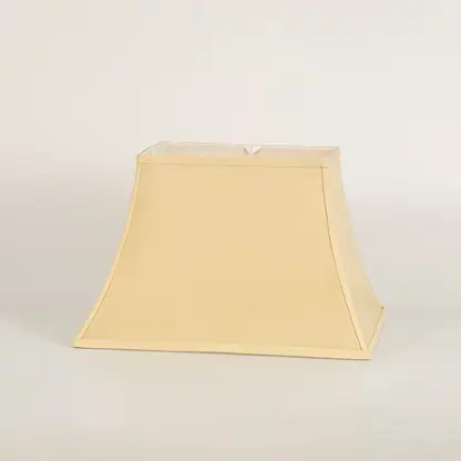 Cream bell shaped lamp shade shown in close up view on plain background for classic elegant lighting décor.
