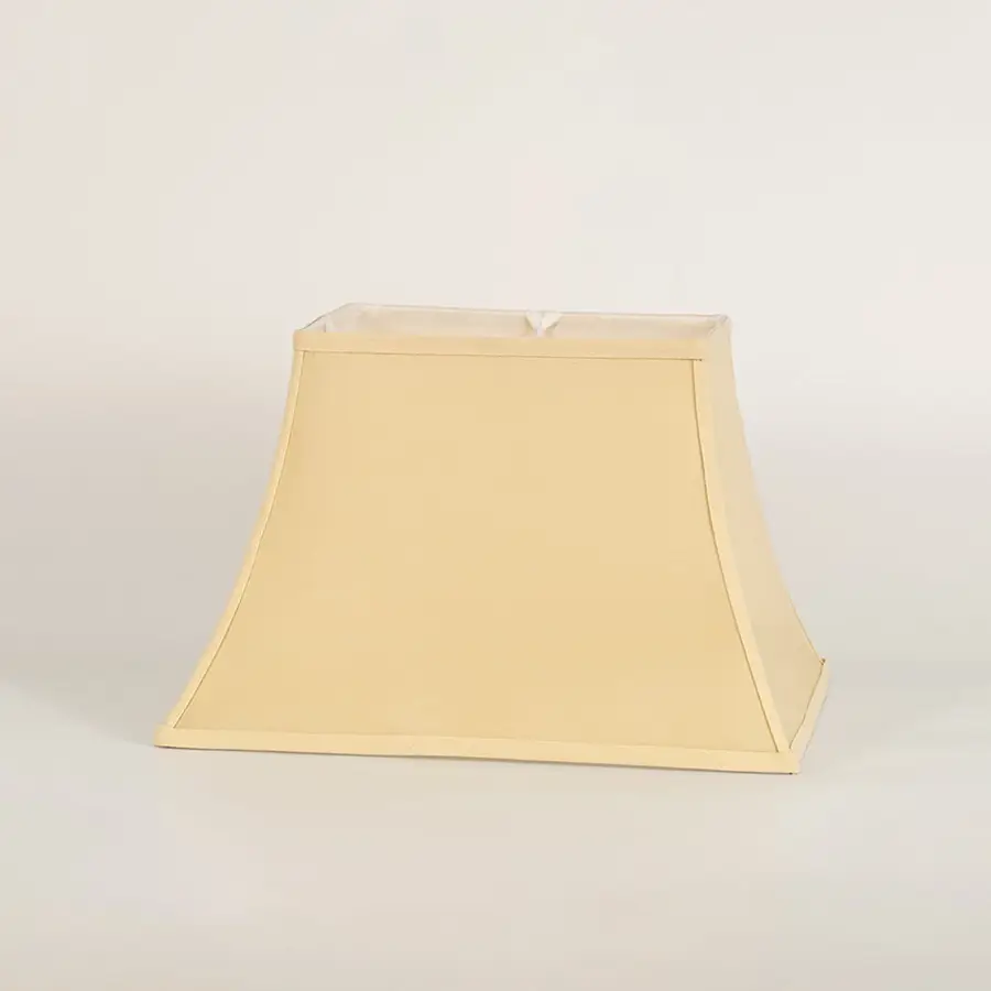 Cream bell shaped lamp shade shown in close up view on plain background for classic elegant lighting décor.