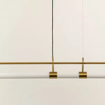 Gold metal linear LED pendant light showcasing sleek craftsmanship and minimalist modern ceiling lighting design.