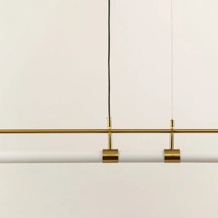 Gold metal linear LED pendant light showcasing sleek craftsmanship and minimalist modern ceiling lighting design.