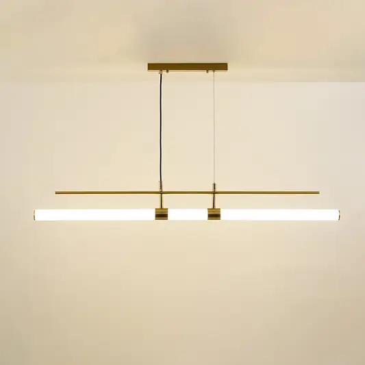 Gold metal linear pendant light with integrated LED bars creating sleek modern ambient lighting for dining spaces.