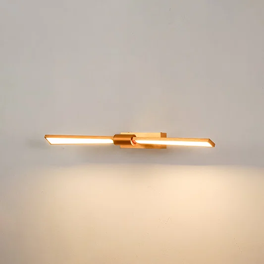 Elegant wall light in gold metal finish with linear bar design for bathroom or vanity decor lighting white background.