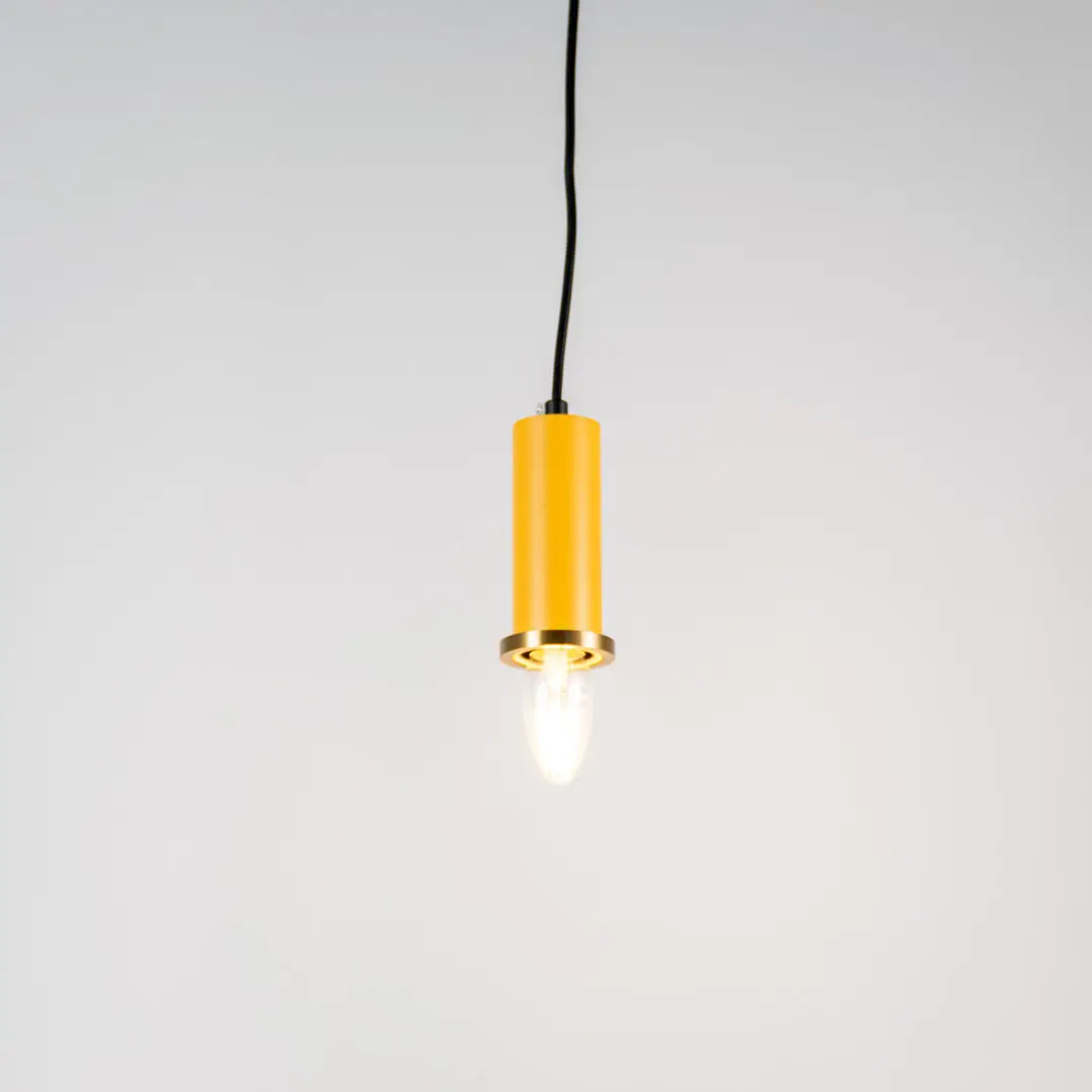 Yellow metal pendant light with brass accents and minimalist cylindrical design for contemporary ceiling lighting decor.