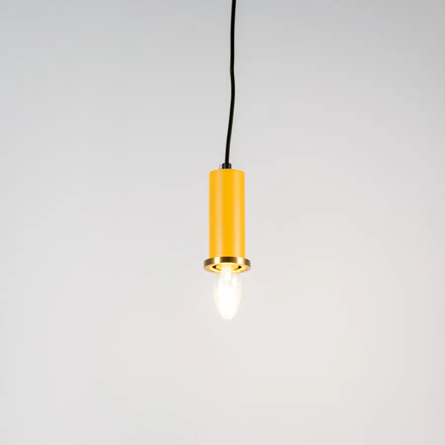 Yellow metal pendant light with brass accents and minimalist cylindrical design for contemporary ceiling lighting decor.
