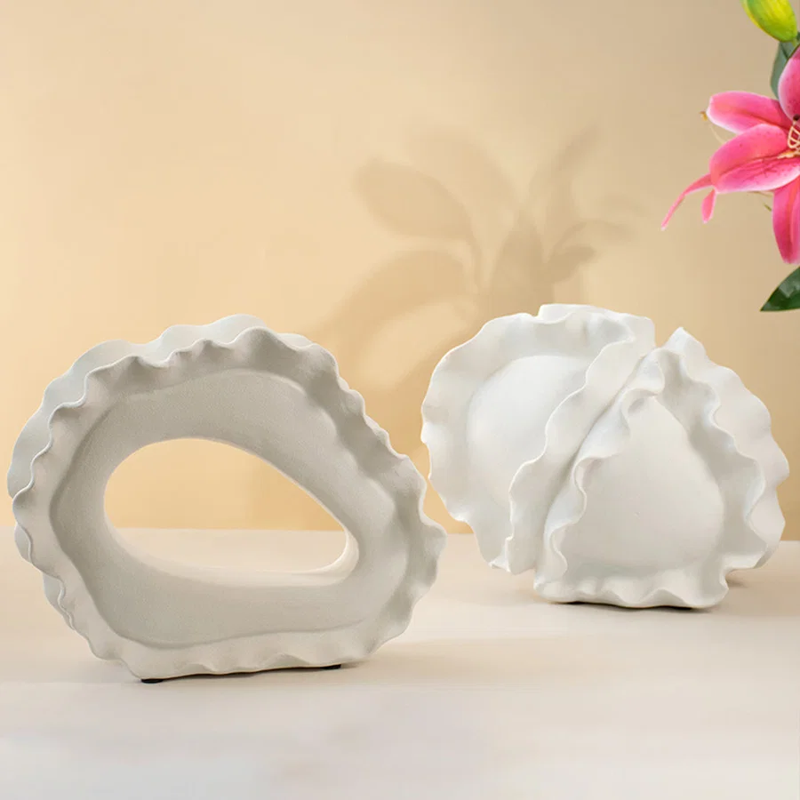 Set of white ceramic decorative bowls with sculptural organic forms for elegant shelf styling and modern home decor.