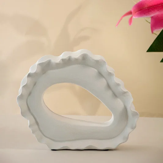 White ceramic decorative bowl with sculptural organic silhouette for contemporary tabletop styling and home decor.