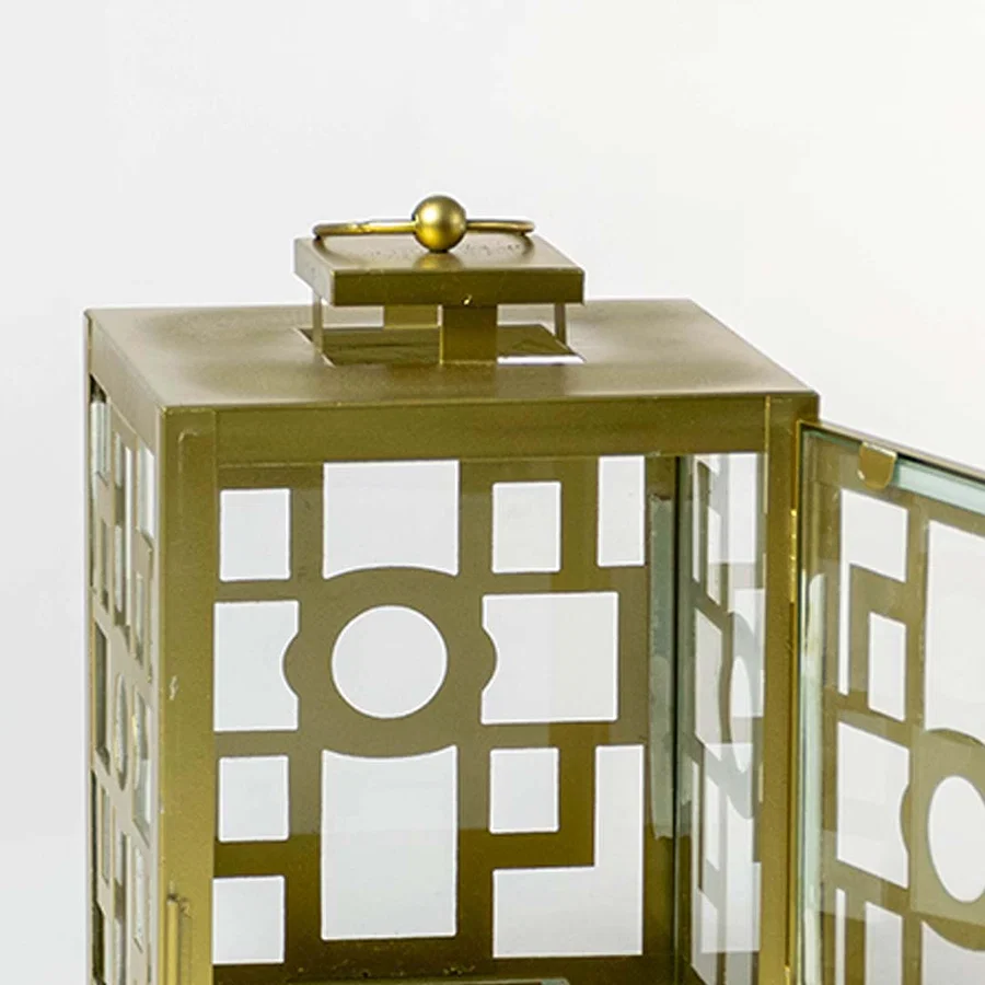 Closeup of gold lantern door detailing showing intricate geometric patterns glass panel clarity and a premium brushed gold finish.