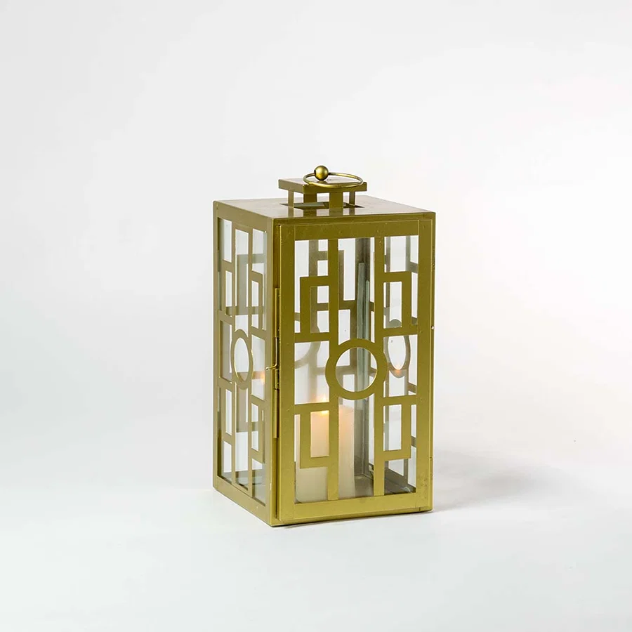 Stylish gold lantern glowing against a dark white background highlighting its elegant metallic finish and intricate geometric grid pattern.