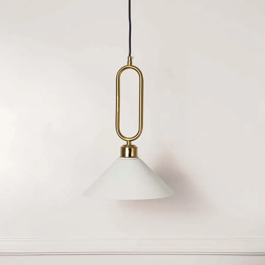 Minimal white glass pendant light with gold geometric holder hanging against soft neutral wall background suitable for luxury interior decor.

