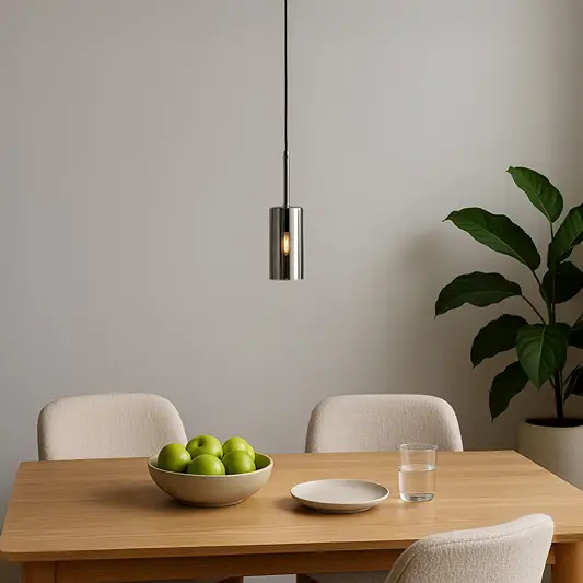Slim chrome pendant light suspended above dining table adding modern elegance and ambient charm.