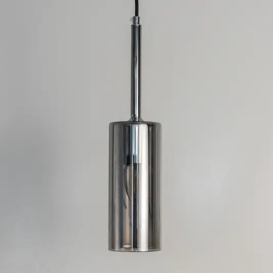 Chrome metal cylindrical pendant light with reflective finish crafted for contemporary interiors.