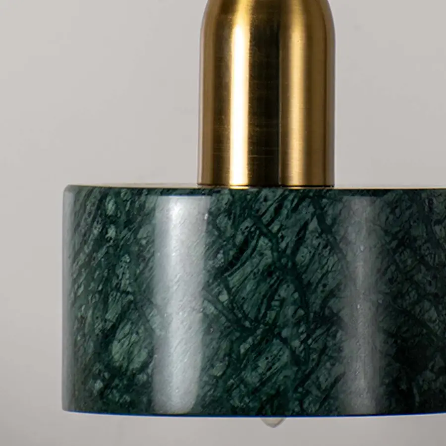 Detailed view of green marble pendant light with gold accents highlighting luxurious texture and craftsmanship.
