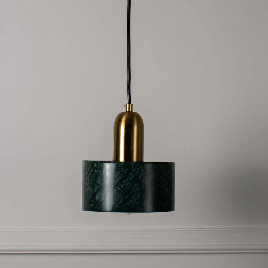 Green marble cylindrical pendant light with polished gold fittings designed for elegant living spaces.