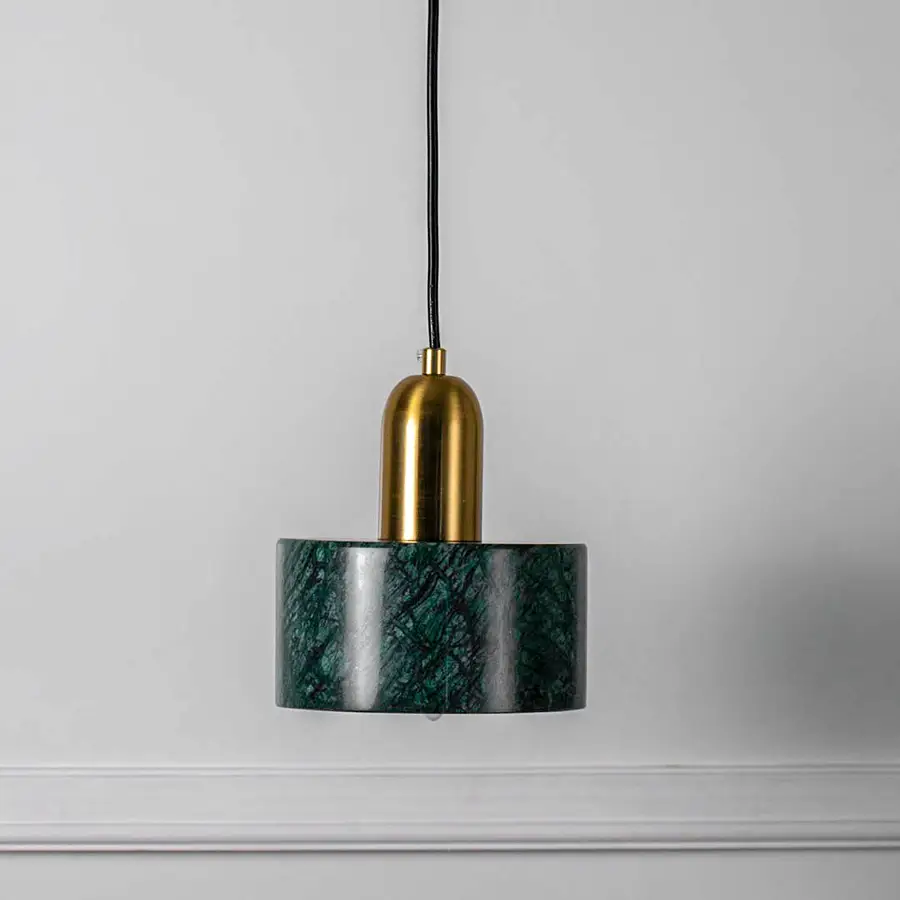 Green textured glass pendant light with gold fixture and hanging cord placed against neutral wall background enhancing elegant contemporary lighting decor appeal.