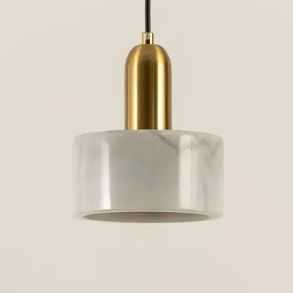 Closeup of white marble pendant light with brushed gold details showcasing premium craftsmanship.