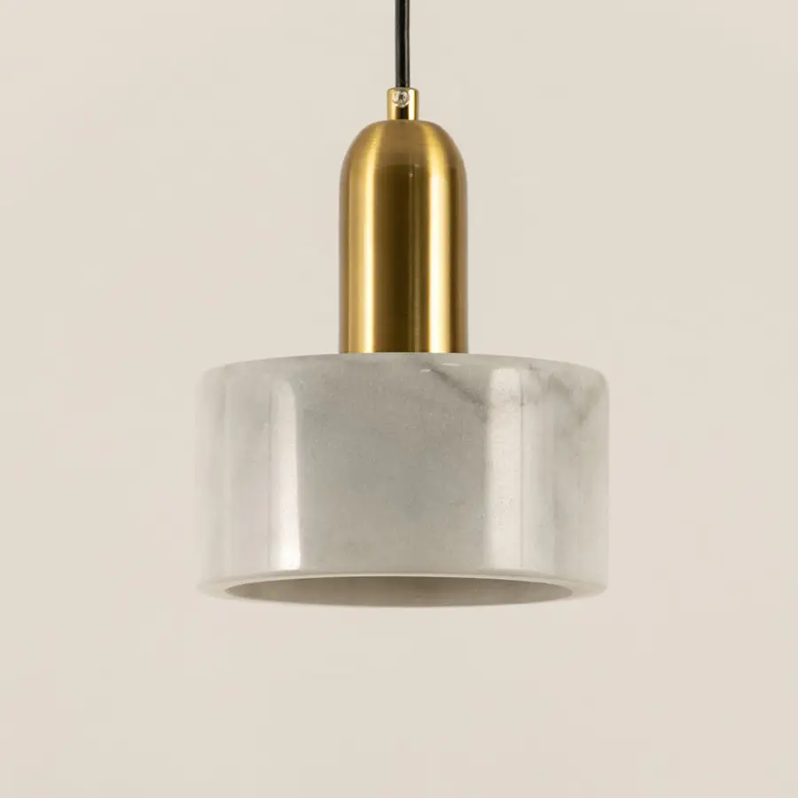 Closeup of white marble pendant light with brushed gold details showcasing premium craftsmanship.