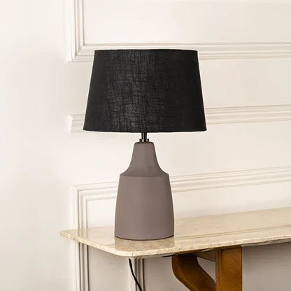 Taupe ceramic table lamp with black fabric shade and minimalist silhouette for sophisticated interior decor styling.