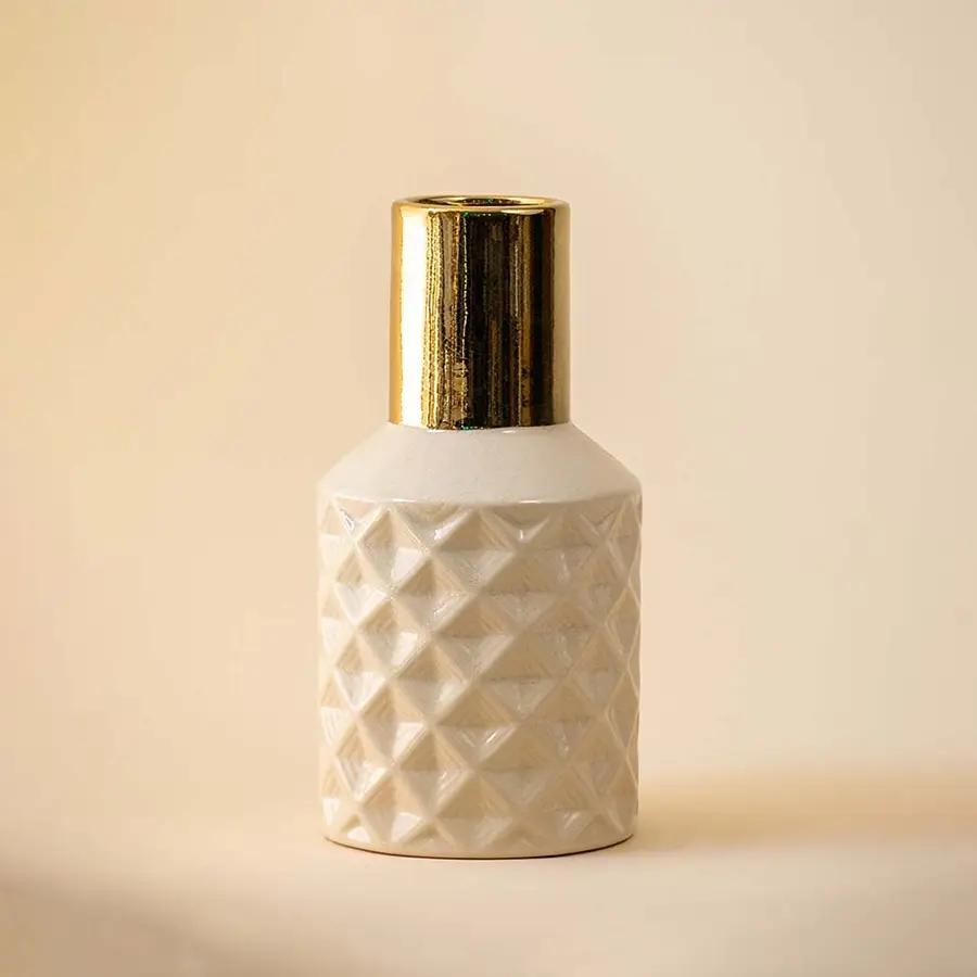 Textured white geometric vase with gold neck for modern luxury home decor and elegant shelf centerpiece style.