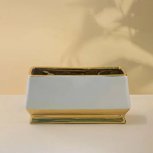 White ceramic decor tray with gold rim and base detail ideal for table top styling in living room or dining space on clean background.