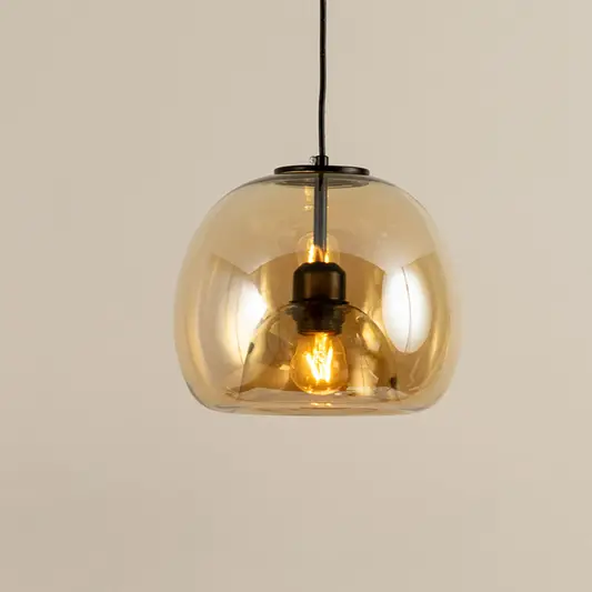 Amber glass and black metal pendant light with reflective finish for stylish modern home decor spaces.