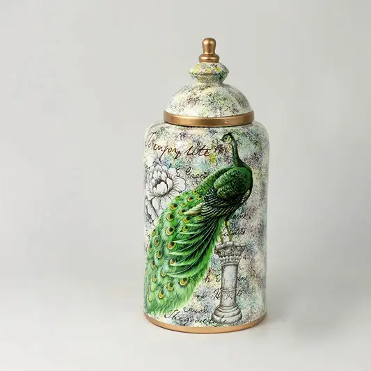 Decorative ceramic jar with parrot and botanical artwork and gold lid placed on white surface against neutral background showcasing luxury artistic home decor styling.