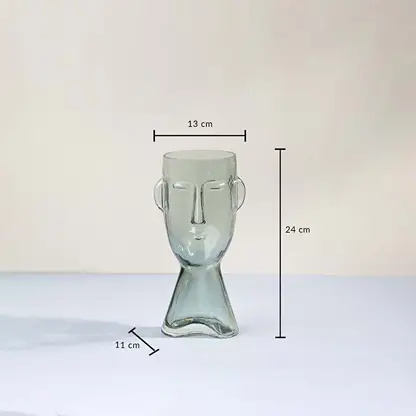 Face shaped glass vase modern abstract design transparent finish decorative accent piece with size shown light on white background.