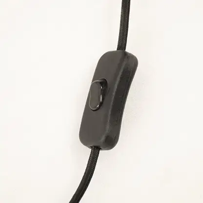 Black inline switch on table lamp power cord designed for convenient operation and reliable everyday lighting control.