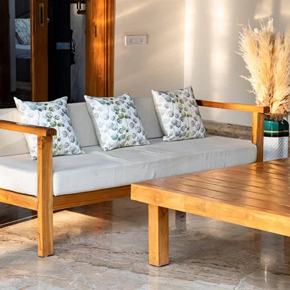 Soft cotton cushion covers with mixed botanical embroidery arranged on an outdoor wooden sofa offering a refreshing nature inspired décor setting with breathable gentle and skin friendly fabrics.