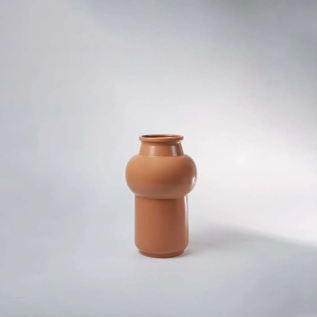 Brown ceramic vase on neutral background emphasizing its clean lines and elegant finish perfect for minimalistic decor styling.