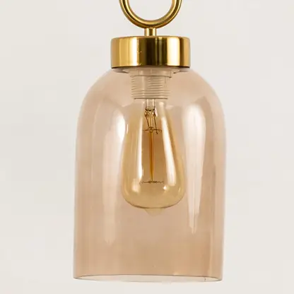 Amber glass pendant light closeup highlighting smooth glass finish and premium contemporary lighting craftsmanship details.