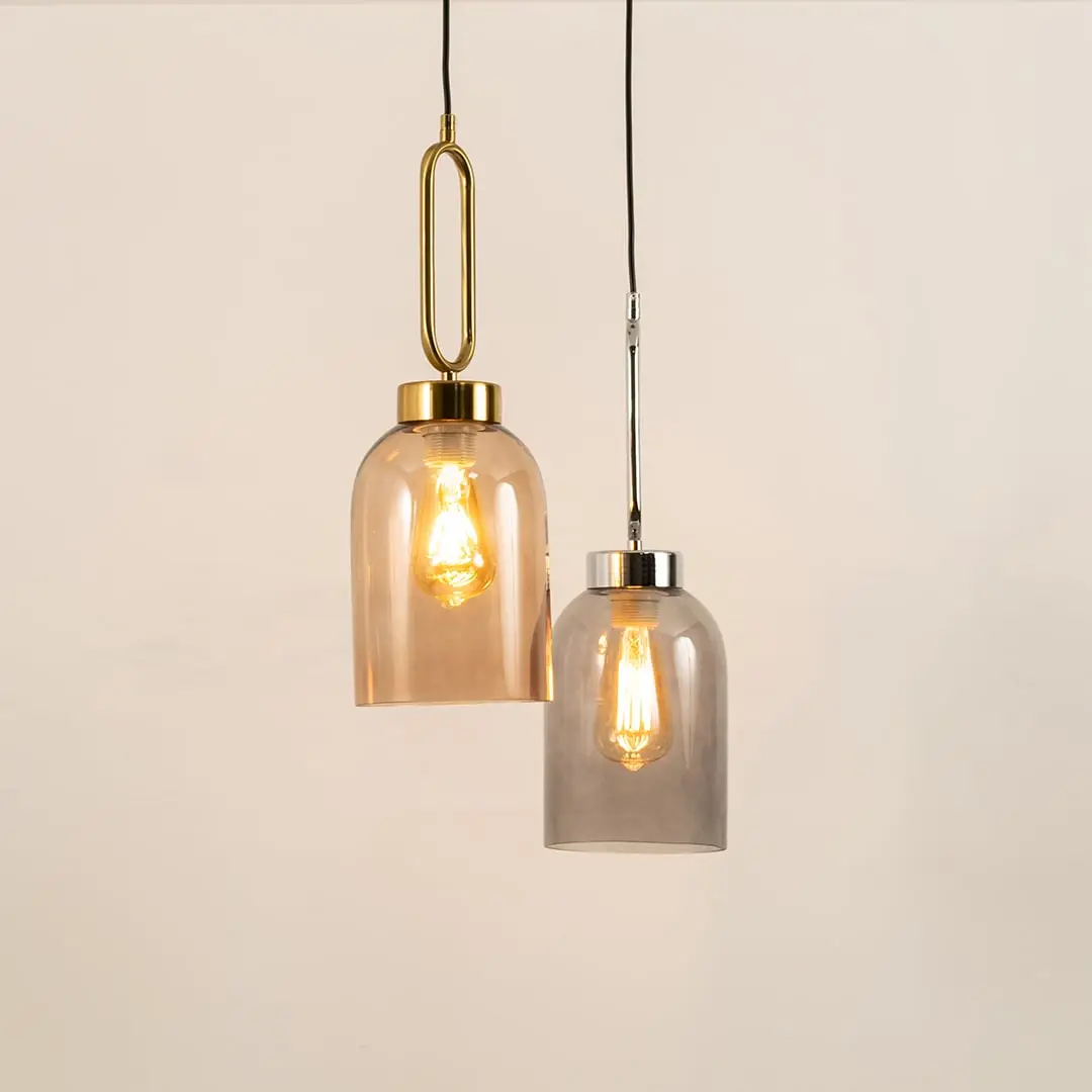 Amber and smoke glass pendant lights enhancing modern interiors with warm ambient lighting and elegant decorative appeal.