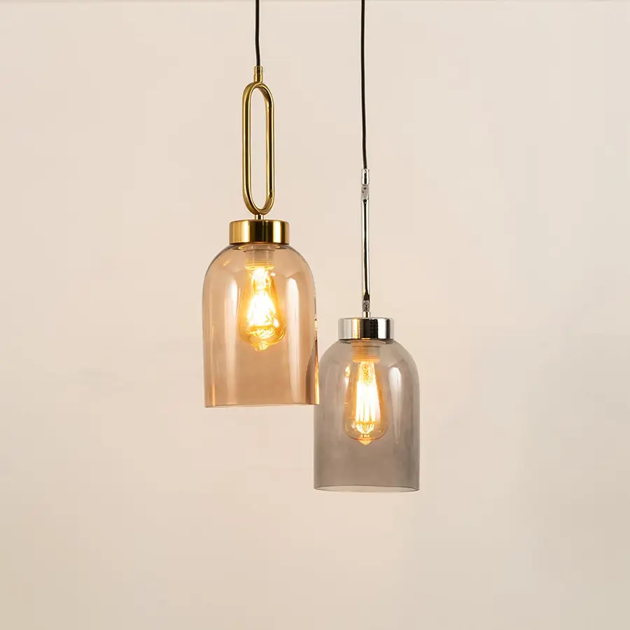 Amber and smoke glass pendant lights enhancing modern interiors with warm ambient lighting and elegant decorative appeal.