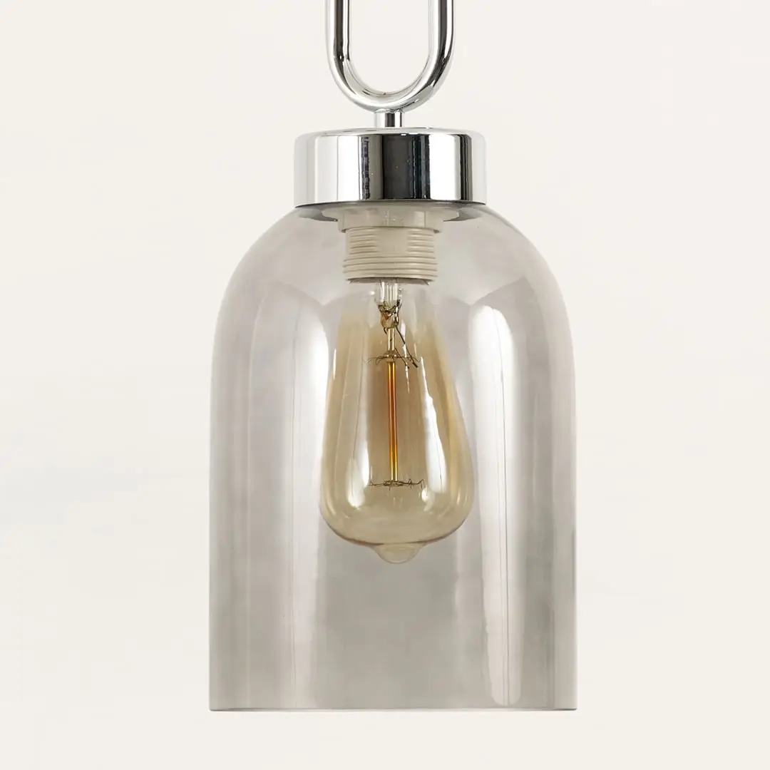 Smoke glass pendant light illuminated to showcase elegant modern ceiling lighting with contemporary decorative appeal.