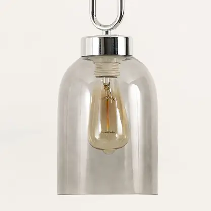 Smoke glass pendant light illuminated to showcase elegant modern ceiling lighting with contemporary decorative appeal.
