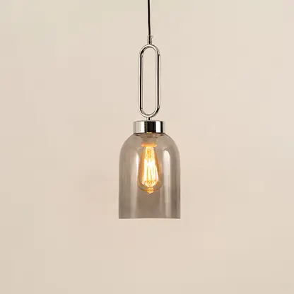 Modern smoked glass pendant light with black metal accents for elegant dining room decor styling.