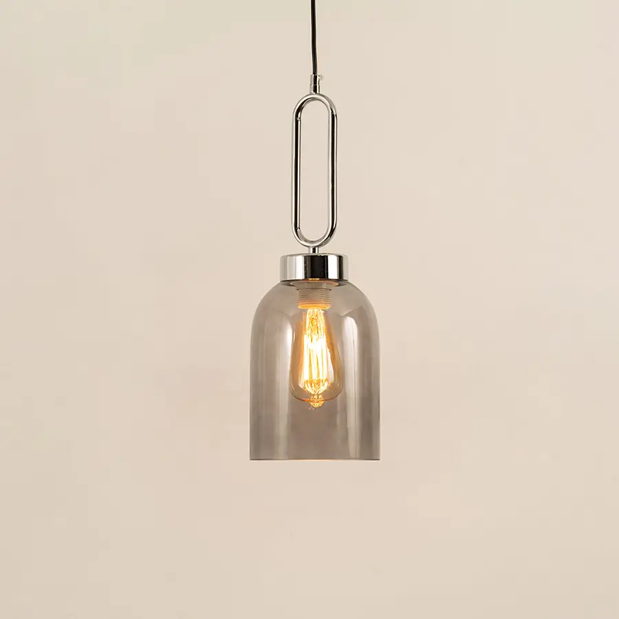 Modern smoked glass pendant light with black metal accents for elegant dining room decor styling.