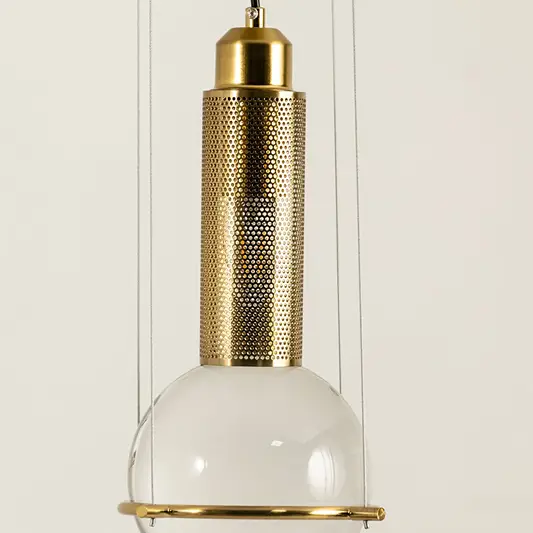 Gold metal pendant light with frosted glass diffuser illuminated to display premium modern ceiling lighting design.