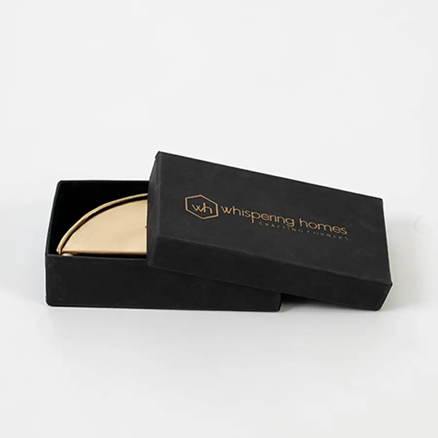 Brass napkin holder packed neatly inside premium black box with soft inserts ideal for gifting and protective storage.