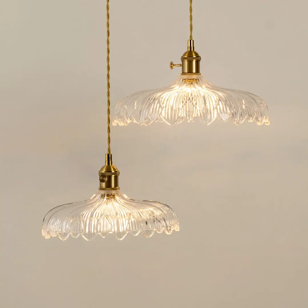 Clear textured glass pendant lights illuminated to highlight premium decorative ceiling lighting and elegant craftsmanship.