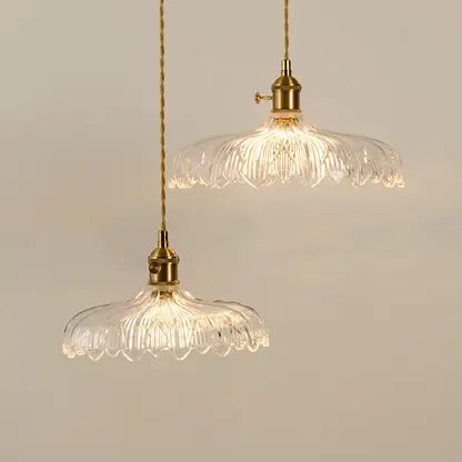 Clear textured glass pendant lights illuminated to highlight premium decorative ceiling lighting and elegant craftsmanship.