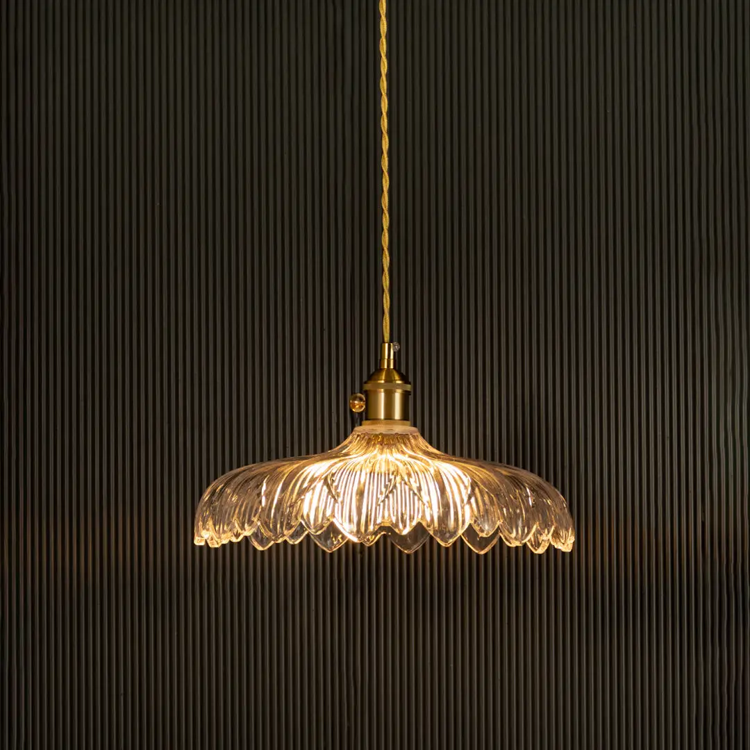 Crystal glass pendant light with gold metal accents glowing beautifully for elegant dining spaces.