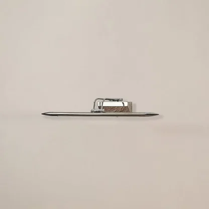 Chrome metal picture light on a white background with the light off highlighting its sleek modern reflective design.