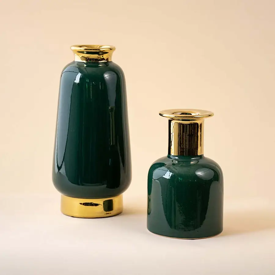 Set of green and gold vases arranged together creating a sophisticated coordinated look for modern and festive decor.