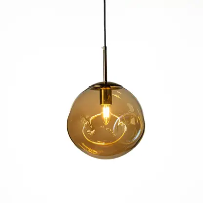 Amber glass globe pendant light with black metal fittings casting a warm glow for stylish interiors.